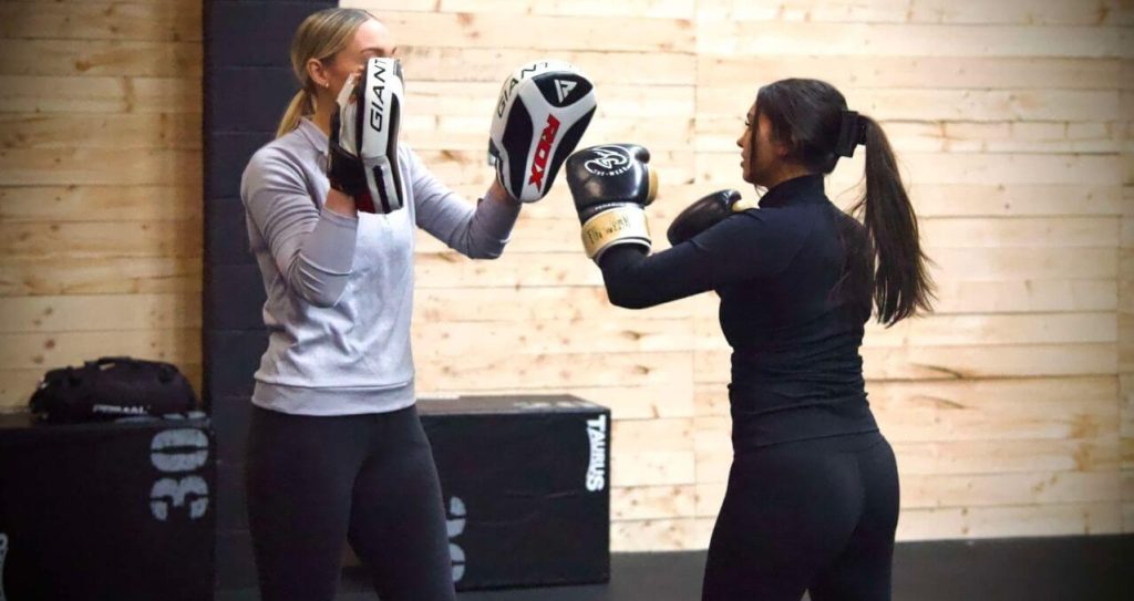 Women training with gloves during punch and sculpt class